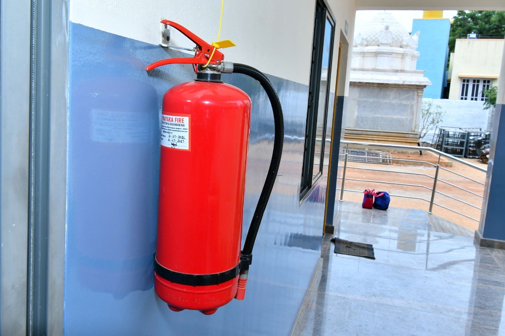 Fire safety extinguisher mounted in school corridor