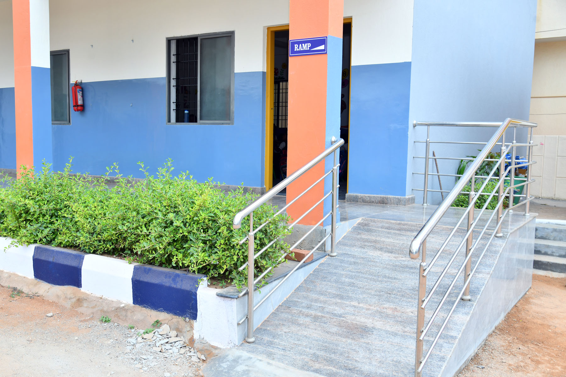 Disabled-friendly CWSN girl's toilet facility with access ramps outside